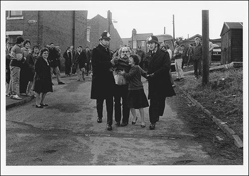 The greetings card of of Josie Smith, a retired and siabled miner, being escorted by police officers after being arrested outside his back gate. His wife is appealing for him to be released.