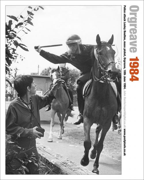 The poster of Lesley Boulton at the Orgreave Coking Plant about to be hit on the head with a truncheon by a moving mounted police officer.