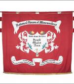 Greetings card of the front of the banner of the South wales Area of the NUM.