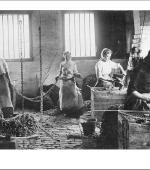 The front of the greetings card of young women chainmakers at work around 1910.